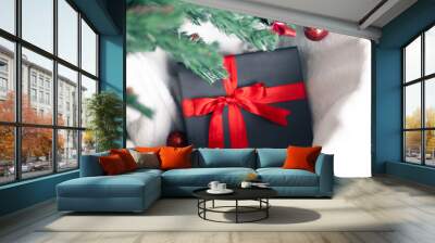 Black gift box with a red bow Wall mural