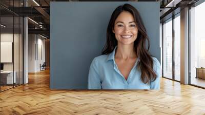 Charming school teacher standing on grey background Wall mural