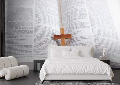 Close up wooden cross on open bible pages Wall mural