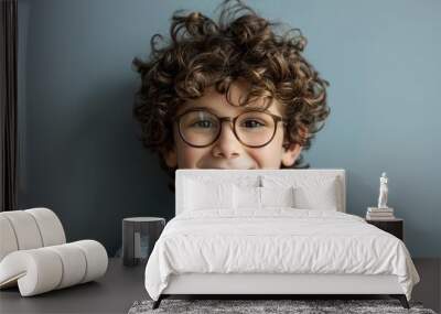 Cute little boy in eyeglasses on grey background Wall mural