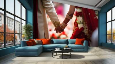 Indian bride and groom holding hands at a wedding ceremony Wall mural