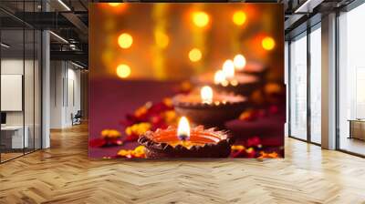 Line of glowing Diwali diyas with flower petals and festive bokeh lights in the background Wall mural