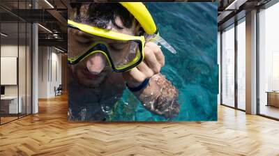 European man snorkeling in the sea. Brunette guy with mask and snorkel for swimming. Diving on vacation Wall mural