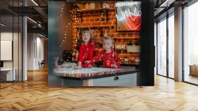 two blondie little sisters play with a red pickup truck on a kitchen island. Wall mural