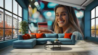 A woman is smiling and holding a credit card in a store. She is happy and seems to be enjoying her shopping experience Wall mural