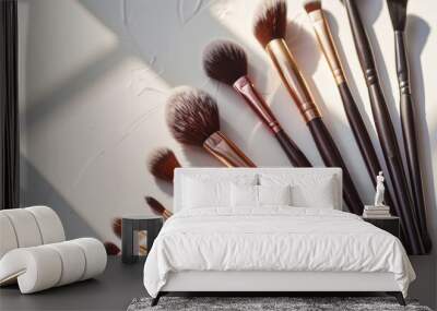 Close-up of a set of professional makeup brushes on a light background in the sun's rays. Stylish makeup brushes on a light table. Makeup and beauty concept. Wall mural