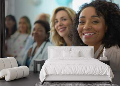 Group of healthcare professionals smiling during a meeting in a warm, well-lit setting Wall mural