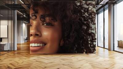 Young African American woman with curly hair posing looking at the camera. Beautiful female model enjoying the weather outdoors. Beauty and fashion concept. Wall mural