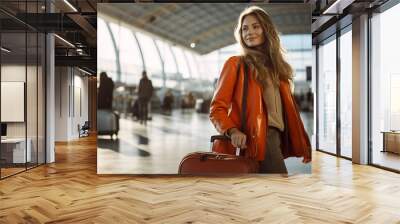 Young beautiful woman at the airport with a suitcase 1 Wall mural