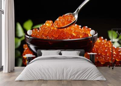 Fresh red caviar in a black bowl on a black background spoon with red caviar Wall mural