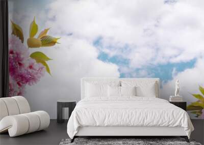 Horizontal banner with beautiful spring sakura flowers on two sides photo on a background of blue sky with lush clouds. Pink cherry flowers, dreamy romantic image of spring. Copy space for text Wall mural