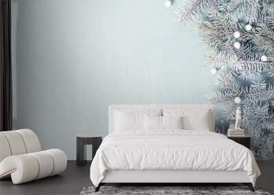 Light blue Christmas or New Year festive background with frosty fir branches Wall mural