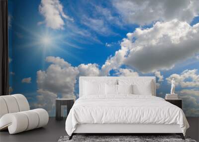 Blue sky with clouds and bright sun. Wall mural