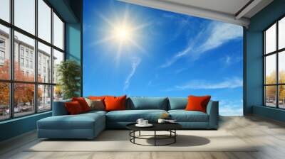 Couds in the blue sky. Bright sun illuminates the space. Wall mural