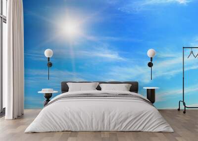 cumulus clouds and a bright sun in the blue sky. Wall mural