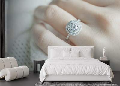 Close up Diamond ring on woman's finger before wedding with white scarf background.(soft and selective focus) Wall mural