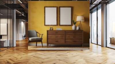 Interior of a room with two chairs, a wooden chest of drawers and yellow walls with large posters in a wooden frame. Wall mural