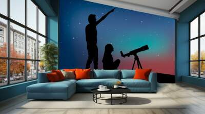 Silhouette of a couple of people with telescope on the starry sky background. Man points to the sky Wall mural