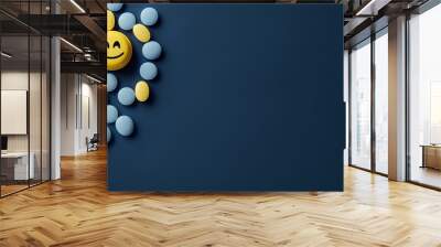 Yellow pill with smiley face and blue pills on blue background. Depression treatment concept Wall mural