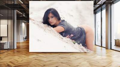 Beautiful athletic sensual woman on sand Wall mural