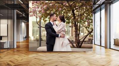 bride and groom in the garden of pink  blooming trees Wall mural