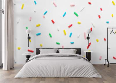 flat lay of colorful sprinkles over white background, festive decoration Wall mural