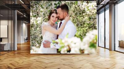 newlyweds in a blooming spring garden Wall mural