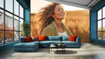 One beauty woman with happy and idyllic expression on face opening arm and enjoying sunset light in the field in scenic outdoor leisure activity. People loving life and healthy lifestyle concept. Life Wall mural