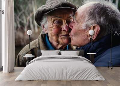 senior woman kissing her husband Wall mural