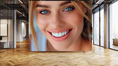 Close-up portrait of a Caucasian girl with blue eyes and blonde hair, smiling a wide smile with beautiful white teeth. Dental services concept Wall mural