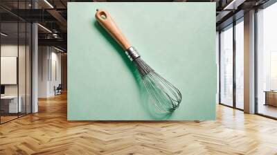 Minimalist kitchen whisk on a pastel mint green backdrop Wall mural