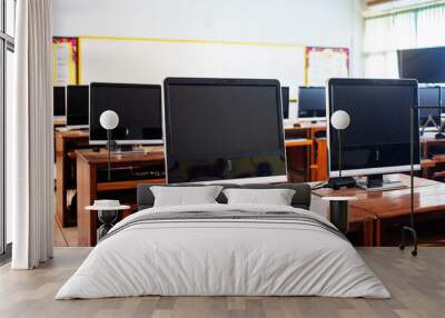 Computers on wooden table in room for education Wall mural