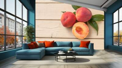 Fresh organic peaches on a yellow rustic table - top view Wall mural