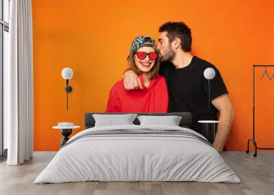 cool couple on orange background Wall mural