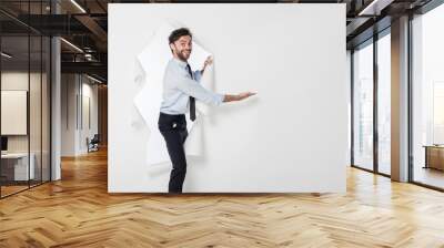 office man with elegant outfit and tie breaking the paper backgr Wall mural