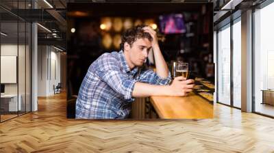 single man sitting at bar having a beer Wall mural