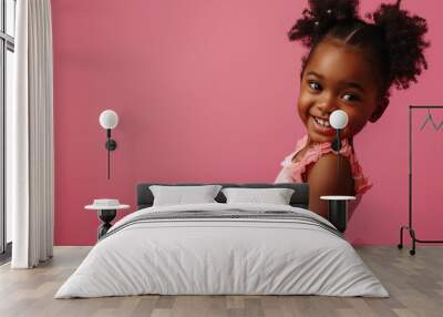 
candid portrait of a little african girl in a pink ballerina tutu posing isolated on a pink pastel background with copy space. concept - advertising of a ballet school, ballet class for children Wall mural