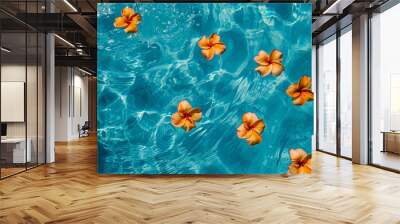 
top view of crystal clear blue pool with tropical orange flowers floating on the surface . Abstract summer beach vacation backdrop Wall mural