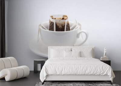 drip or brewed coffee in white cup on white backdrop. paper dripping bag on a cup Wall mural