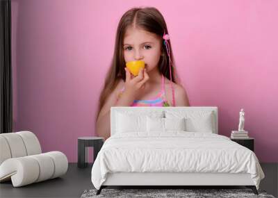 Caucasian beautiful little girl with fresh yellow . Little girl with lemon Wall mural