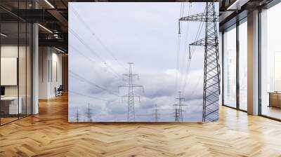 High voltage lines and power pylons on dramatic sky Wall mural