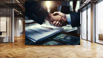 Two people shaking hands in a close-up shot over a paper. Suitable for business, partnership, and contract-related concepts. Wall mural