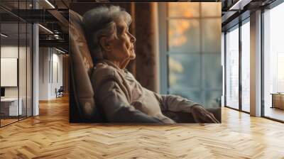 A senior elderly man look outside through the window Wall mural