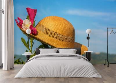 Female straw hat on  background of blue sky Wall mural