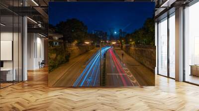 Night drive with light trails of cars in the bavarian cpaital Munich by low light. Wall mural