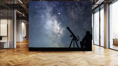 Man with astronomy  telescope looking at the stars. Wall mural