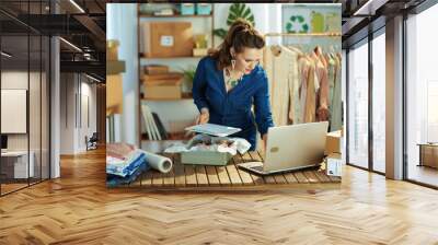 40 years old business owner woman using laptop in office Wall mural