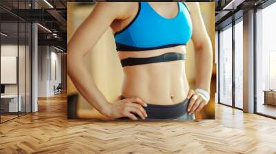 Closeup on fit sports woman wearing heart rate monitor Wall mural