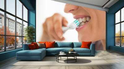 Closeup on young woman brushing teeth Wall mural