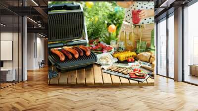 desk with electric grill and grilled sausages Wall mural